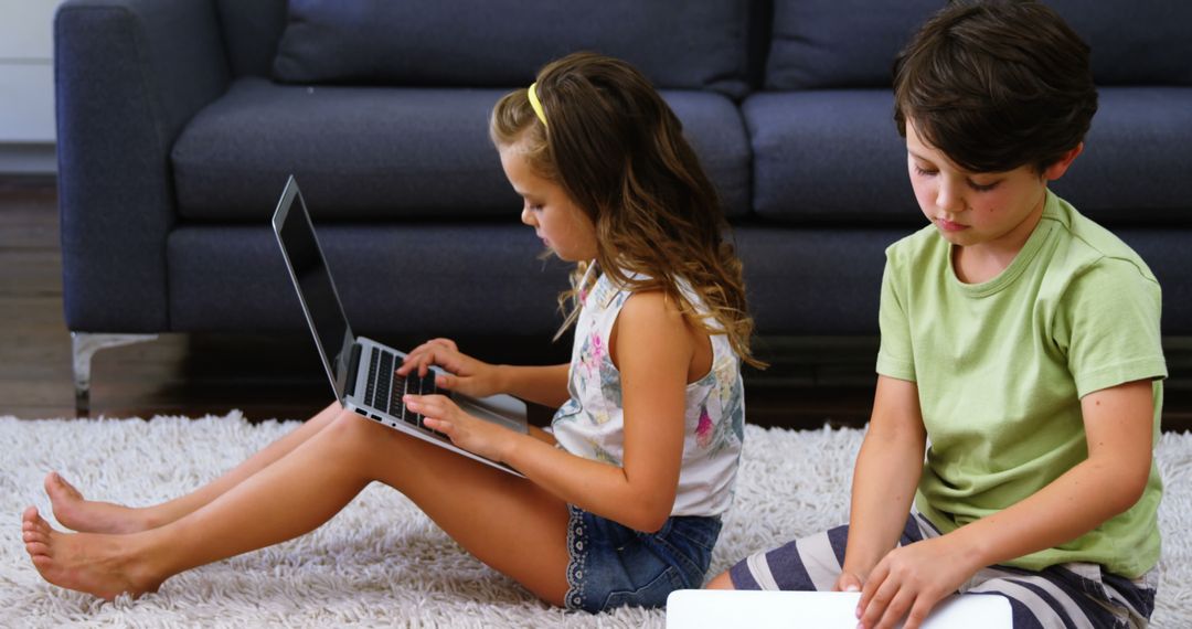 Children Using Laptops on Floor in Living Room - Free Images, Stock Photos and Pictures on Pikwizard.com