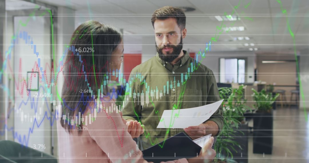 Business Colleagues Analyzing Data With Digital Projections In Office