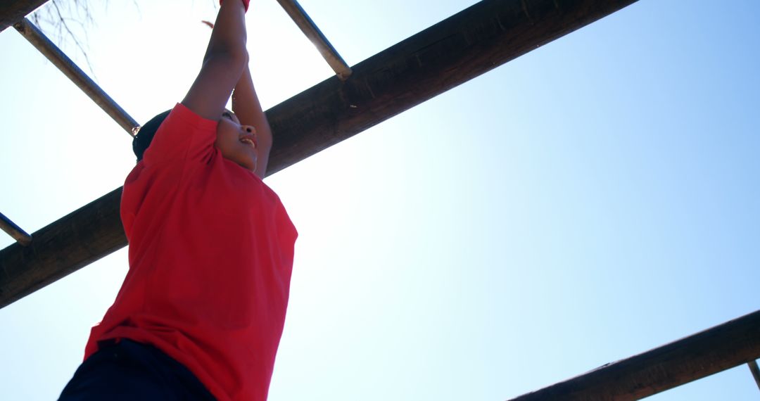 Child Enjoying Outdoor Monkey Bars on Sunny Day - Free Images, Stock Photos and Pictures on Pikwizard.com