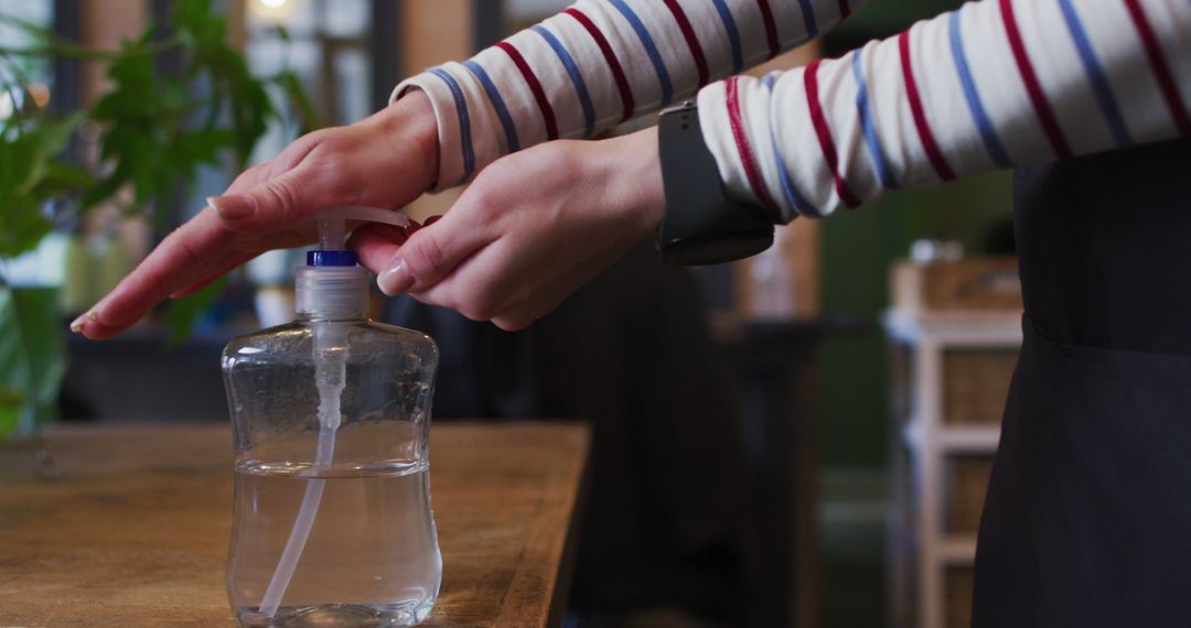 Close-Up of Person Using Hand Sanitizer in Indoor Setting - Free Images, Stock Photos and Pictures on Pikwizard.com