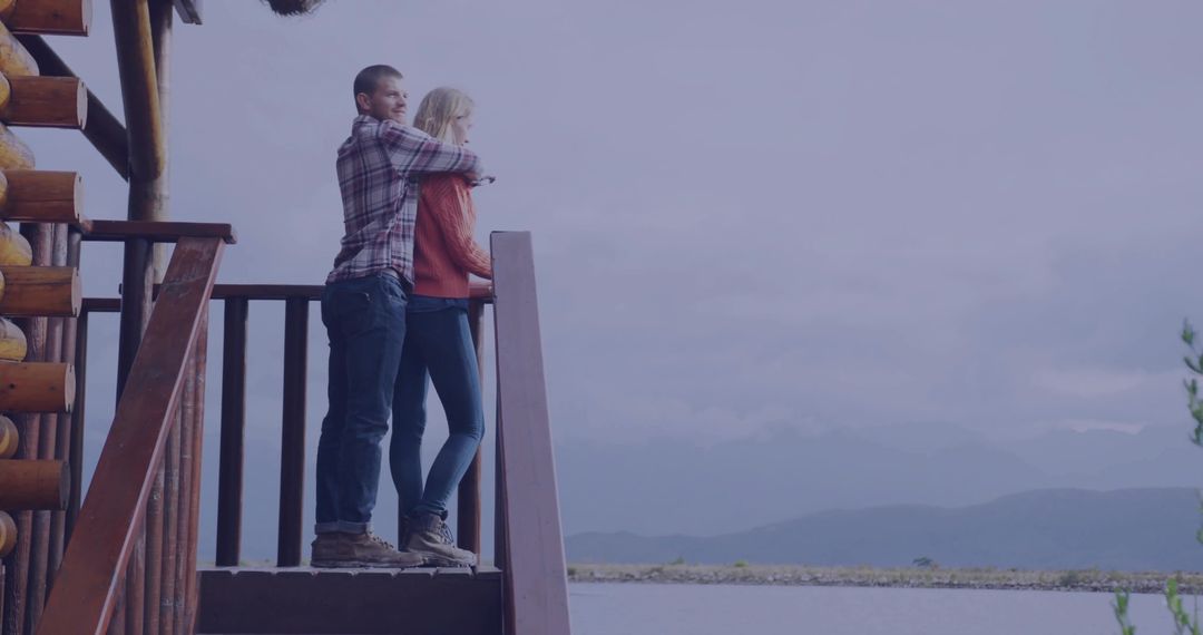 Couple Embracing While Overlooking Scenic Lakeside Mountain View