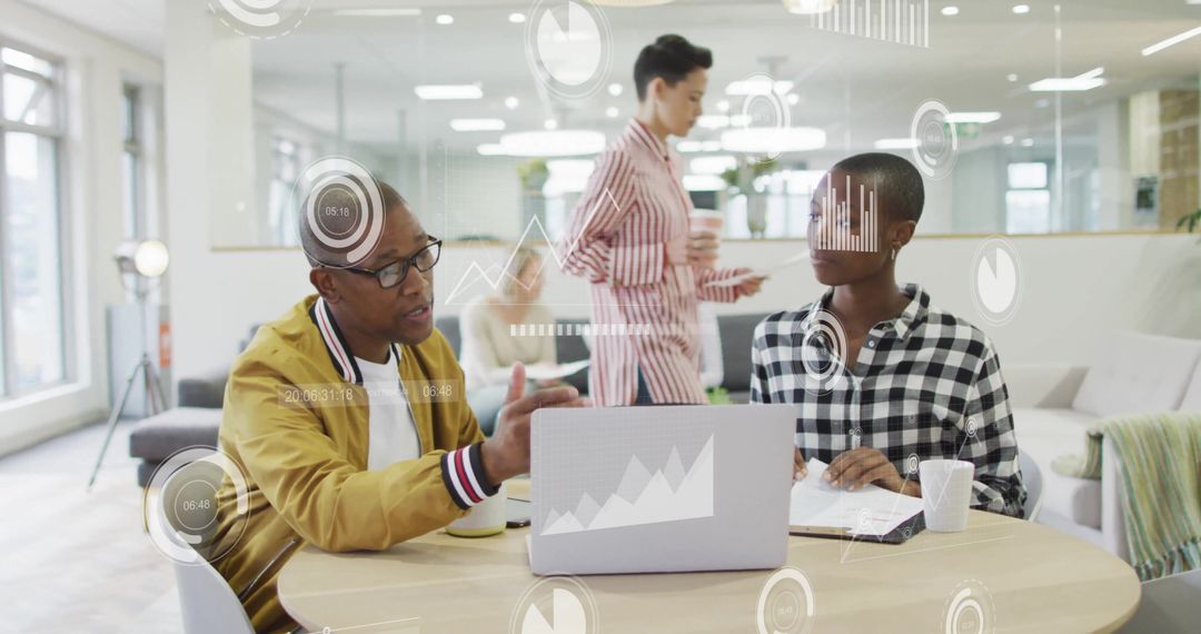 Diverse Colleagues Analyzing Data in Modern Office with Digital Diagrams