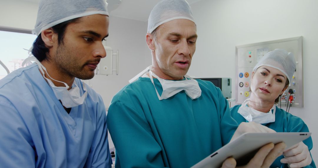 Medical Team Discussing Patient Information Using Digital Tablet - Free Images, Stock Photos and Pictures on Pikwizard.com