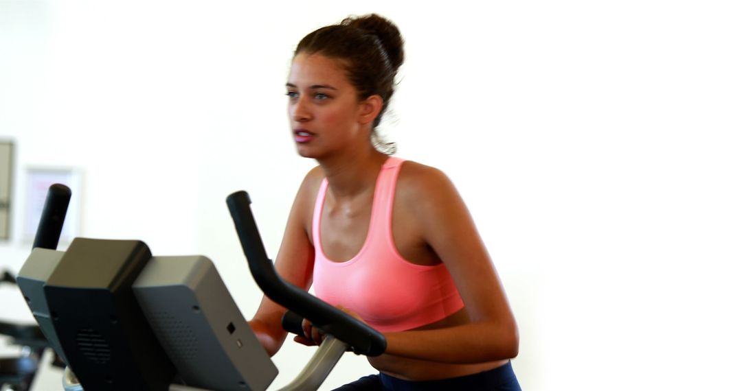 Woman Using Exercise Bike in Gym - Free Images, Stock Photos and Pictures on Pikwizard.com