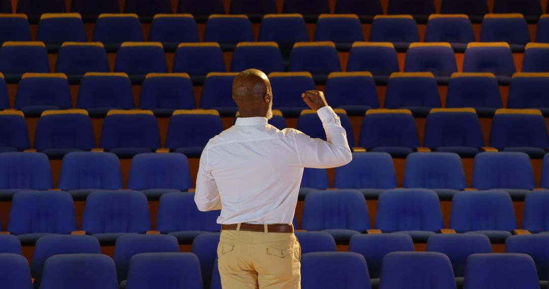 Senior Businessman Preparing Speech in Empty Auditorium