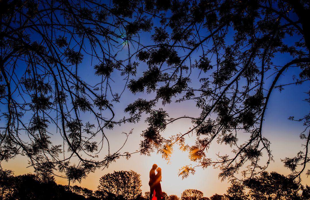 Romantic Couple Embracing at Sunset in Nature - Free Images, Stock Photos and Pictures on Pikwizard.com