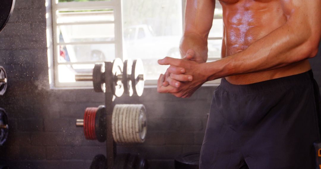 Gym Enthusiast Applying Chalk Powder Ready for Workout - Free Images, Stock Photos and Pictures on Pikwizard.com