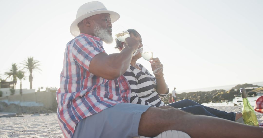 Senior Couple Relaxing on Beach Drinking Wine, Enjoying Sunset - Free Images, Stock Photos and Pictures on Pikwizard.com