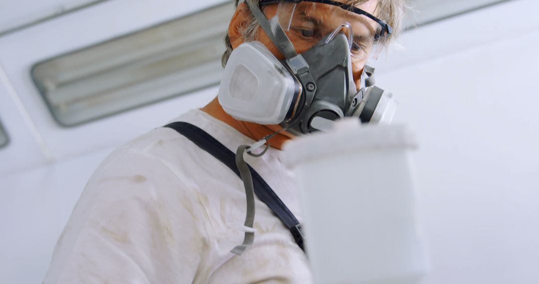 Professional Painter Wearing Respirator in Protective Gear - Free Images, Stock Photos and Pictures on Pikwizard.com