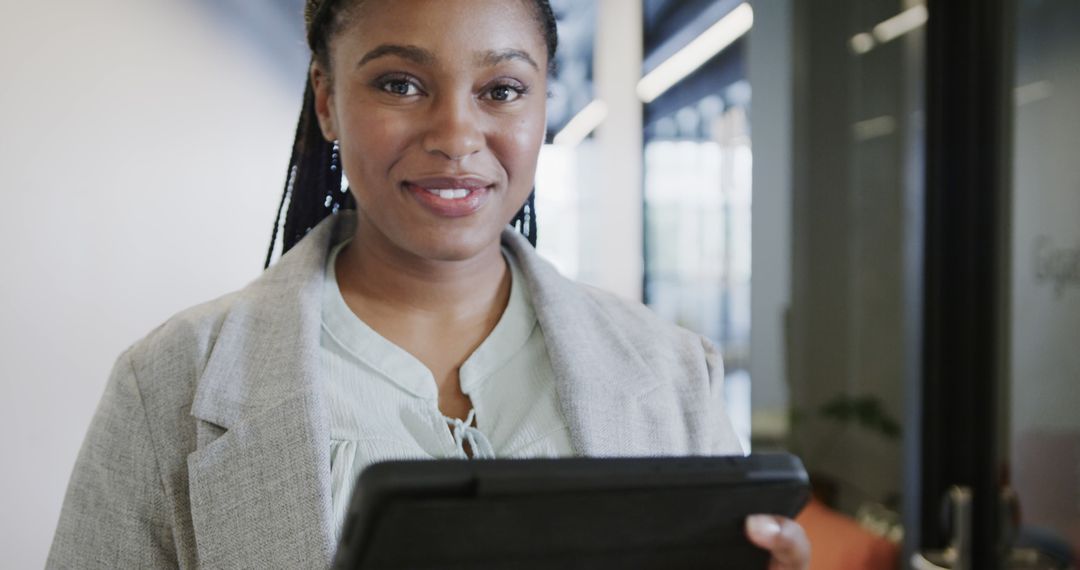 Confident African American Businesswoman with Tablet Smiling in Office - Free Images, Stock Photos and Pictures on Pikwizard.com