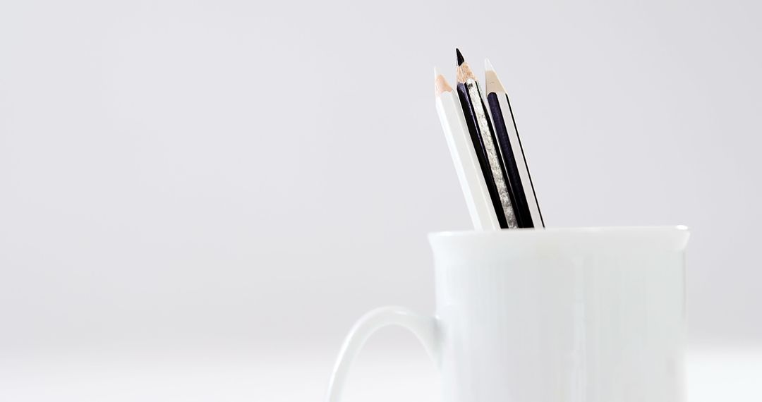 Pencils of varying lengths are arranged in a white mug, with copy space - Free Images, Stock Photos and Pictures on Pikwizard.com