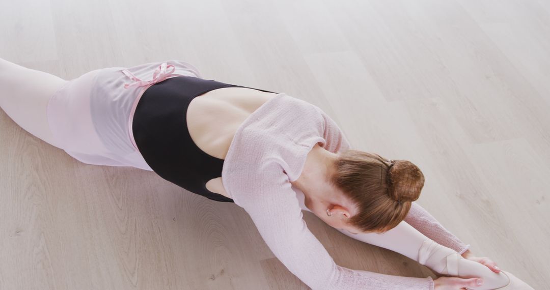 Ballet Dancer Stretching on Floor in Studio - Free Images, Stock Photos and Pictures on Pikwizard.com