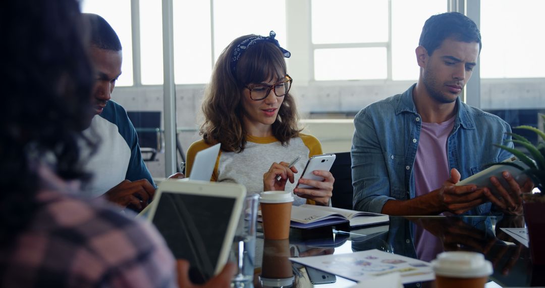Diverse Young Adults Collaborating in Modern Workspace