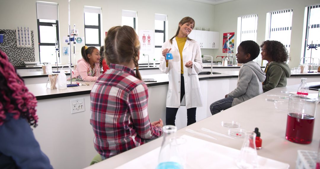 Teacher Leading Science Experiment with Enthusiastic Students in Laboratory