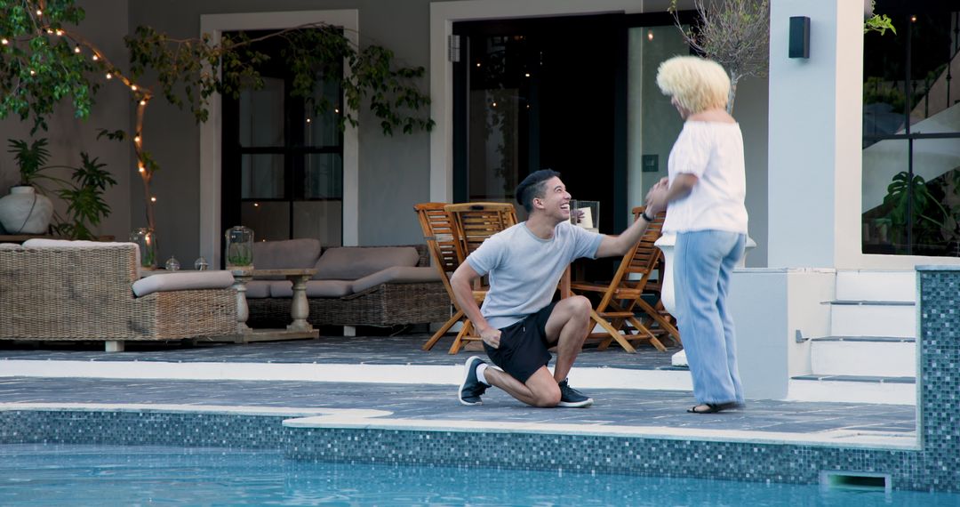 Man Proposing to Partner by Poolside Terrace