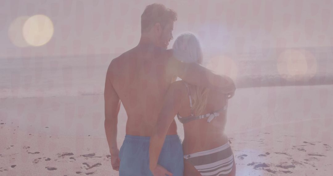 Couple Embracing on Sunlit Beach During Romantic Sunset