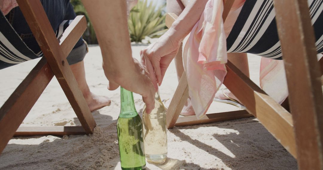 Senior Couple Relaxing on Sandy Beach with Refreshments