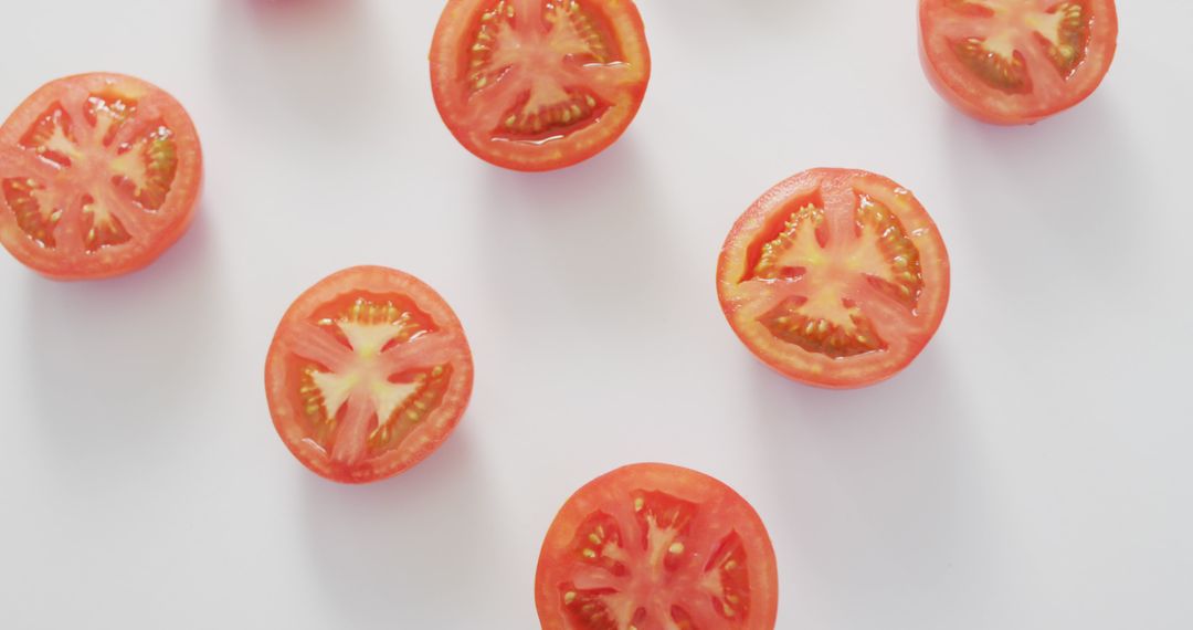 Image of fresh halved red tomatoes on white background - Free Images, Stock Photos and Pictures on Pikwizard.com