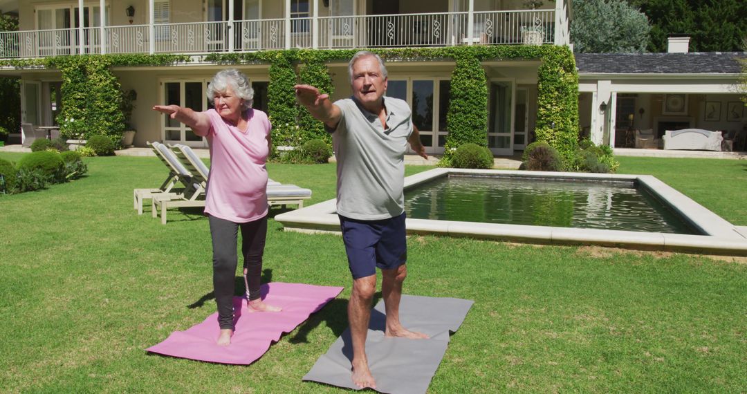 Happy caucasian senior couple practicing yoga in garden standing and stretching in the sun - Free Images, Stock Photos and Pictures on Pikwizard.com