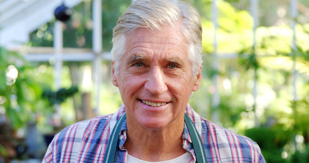 Smiling Senior Man in Greenhouse with Plants - Free Images, Stock Photos and Pictures on Pikwizard.com