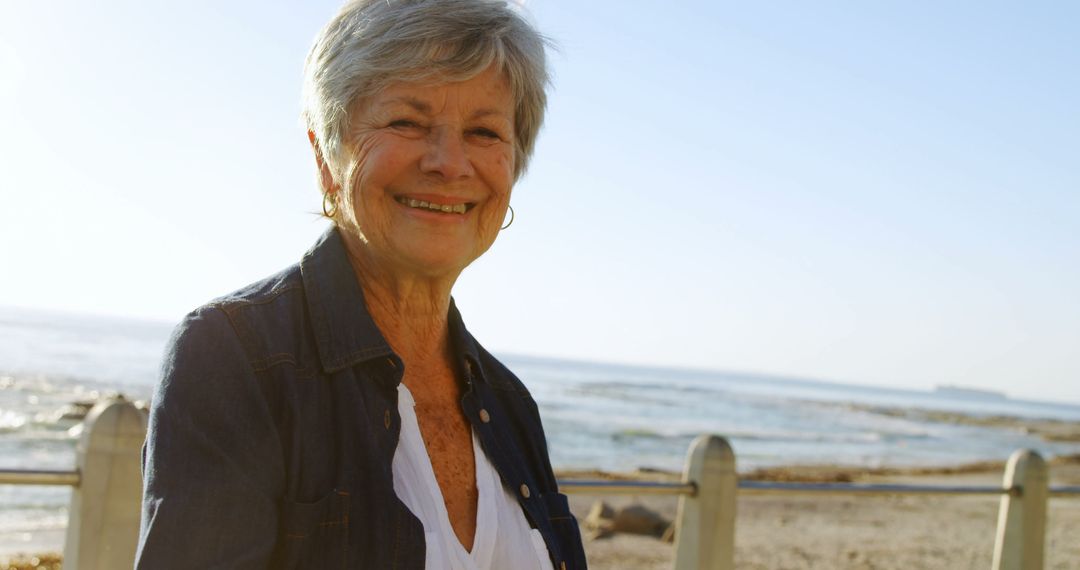 Smiling Senior Woman Enjoying a Day at the Beach - Free Images, Stock Photos and Pictures on Pikwizard.com