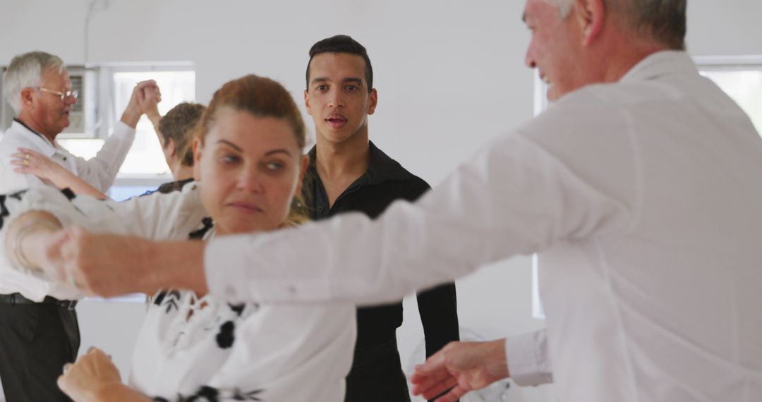 Attentive Dance Instructor Observing Senior Ballroom Class