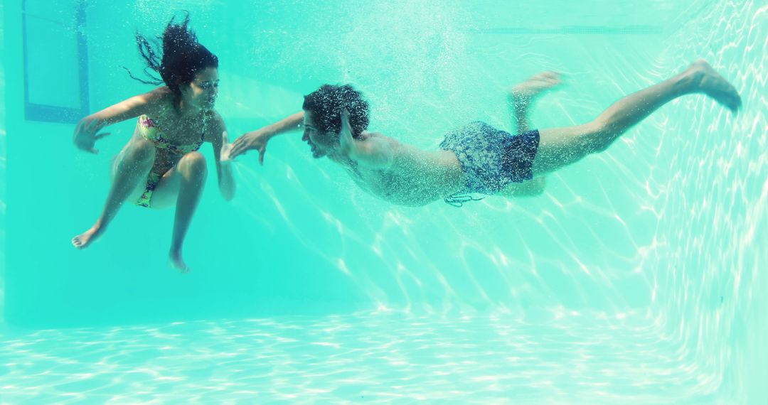 Children Enjoying Underwater Swim in Sunny Pool - Free Images, Stock Photos and Pictures on Pikwizard.com