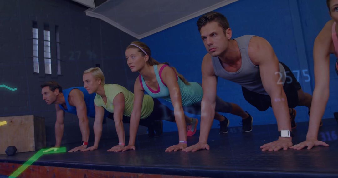 Group Holding Plank Pose for Core Strength in Modern Gym