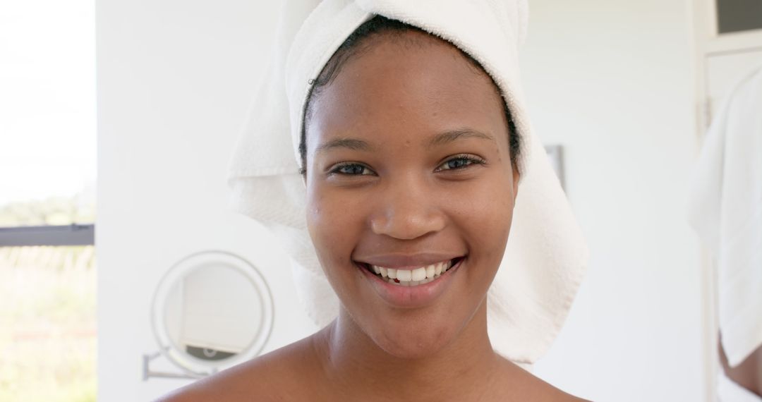 Smiling Woman with a Towel Wrapped Around Her Head After Shower - Free Images, Stock Photos and Pictures on Pikwizard.com