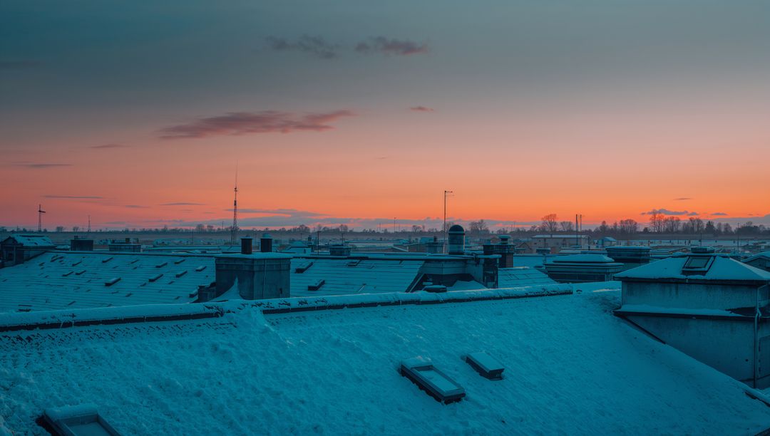 Snow-Covered Urban Rooftops at Dawn Skyline with Skylights and Chimneys, Winter Panorama