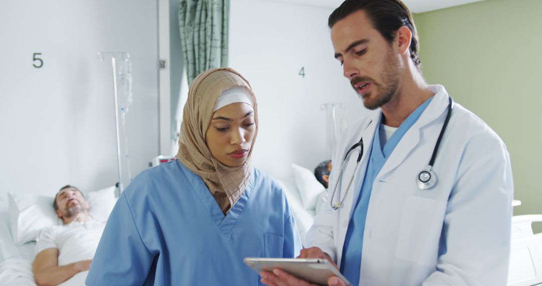 Diverse Medical Team Discussing Patient's Chart in Hospital Ward - Free Images, Stock Photos and Pictures on Pikwizard.com