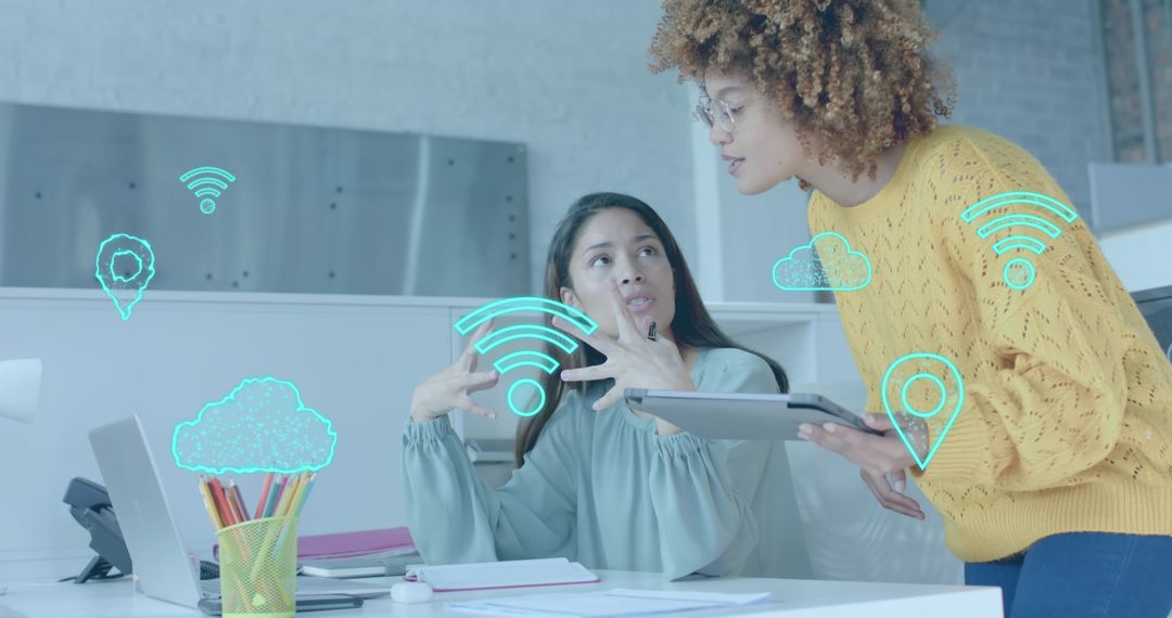 Women Collaborating with Digital Interface Icons in Modern Office