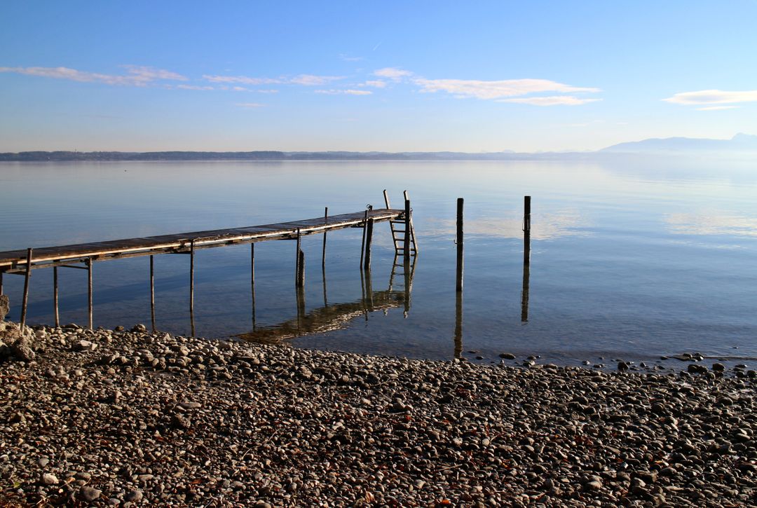 Serene Lakeside View with Wooden Pier on Calm Day - Free Images, Stock Photos and Pictures on Pikwizard.com
