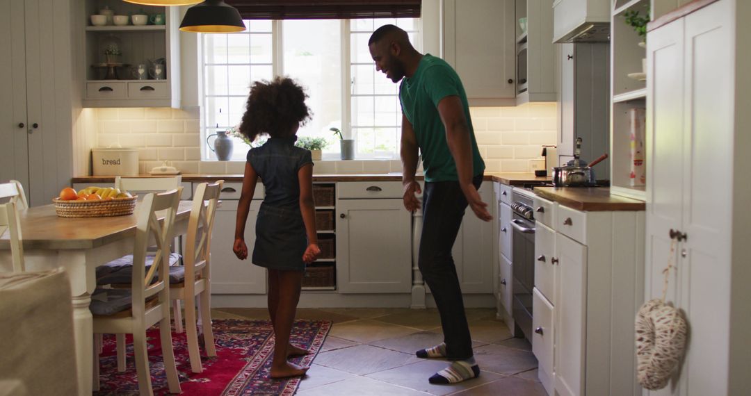 Father and Daughter Dancing in Kitchen Together - Free Images, Stock Photos and Pictures on Pikwizard.com