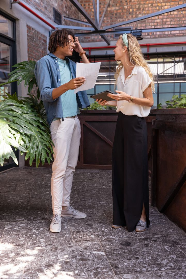Coworkers Engaged in Discussion in Modern Coworking Lounge