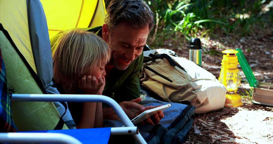 Father and Son Relaxing at Campsite Tent Outdoor Adventure - Free Images, Stock Photos and Pictures on Pikwizard.com