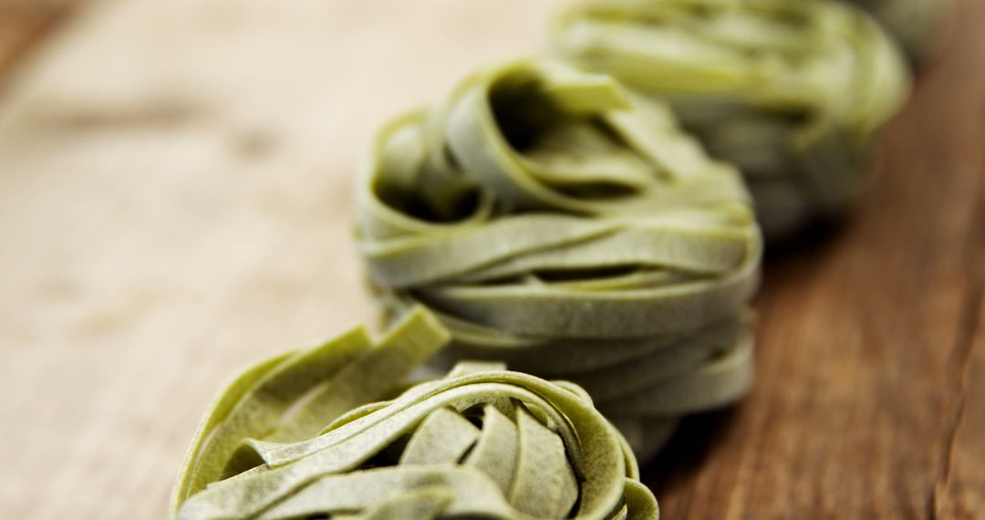 Healthy green spinach tagliatelle noodles arranged on rustic wooden table - Free Images, Stock Photos and Pictures on Pikwizard.com