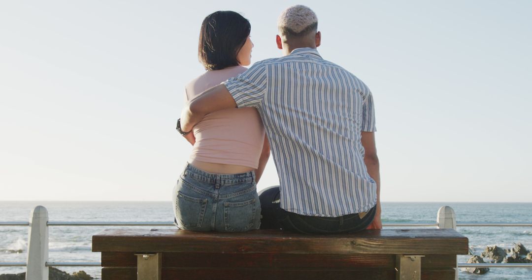 Interracial Couple Sitting on Bench by Ocean, Embracing at Sunset - Free Images, Stock Photos and Pictures on Pikwizard.com