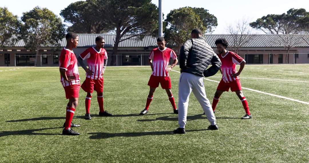 Soccer Coach Guiding Team During Field Practice Session