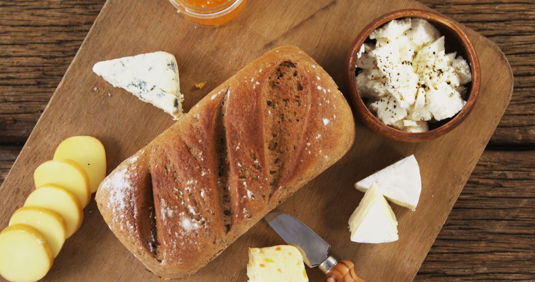 Rustic Bread with Assorted Cheeses on Wooden Board - Free Images, Stock Photos and Pictures on Pikwizard.com