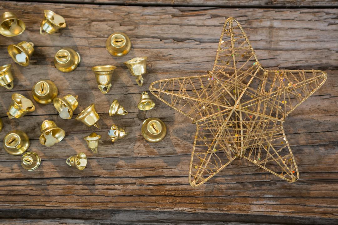 Golden Christmas Bells and Star on Rustic Wooden Plank - Free Images, Stock Photos and Pictures on Pikwizard.com
