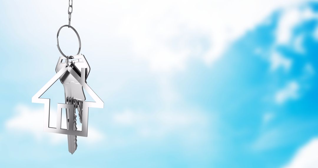 House-Shaped Keychain Floating Against Blue Sky