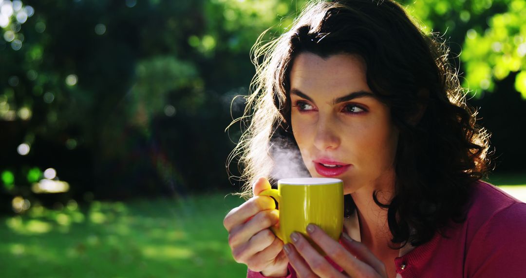 Woman Drinking Coffee in Sunny Park - Free Images, Stock Photos and Pictures on Pikwizard.com