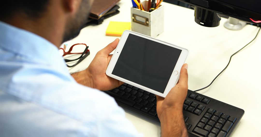 Businessman Using Digital Tablet at White Desk - Free Images, Stock Photos and Pictures on Pikwizard.com