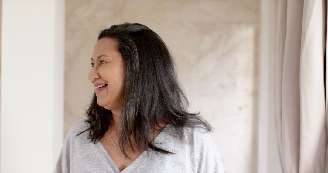 Middle Aged Woman Smiling in Elegant Minimalist Room