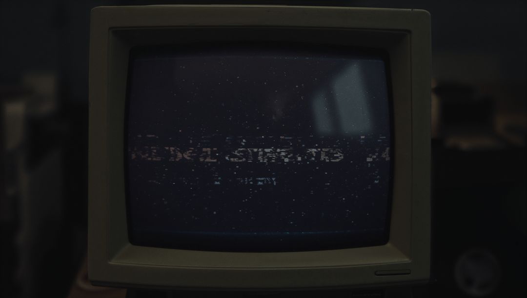 Retro CRT Monitor Displaying Static in Workshop Setting