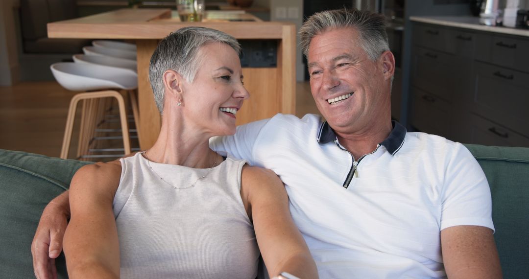 Senior Couple Relaxing Together on Sofa in Modern Home