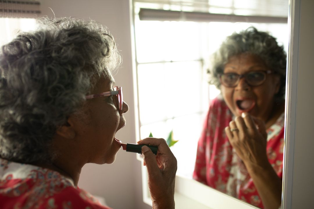 Senior African American Woman Applying Lipstick at Home - Free Images, Stock Photos and Pictures on Pikwizard.com