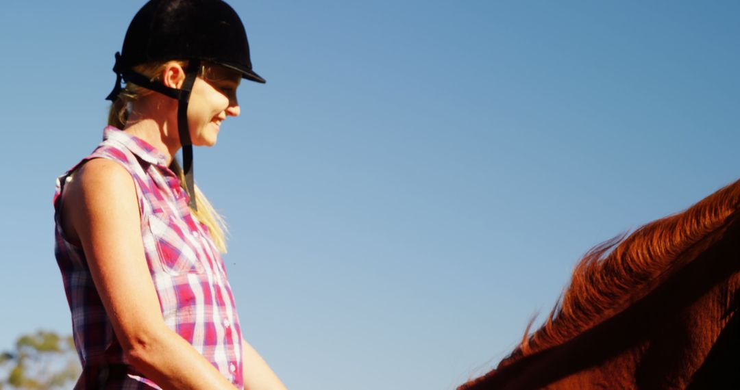 Young Woman Riding Horse on Sunny Day - Free Images, Stock Photos and Pictures on Pikwizard.com