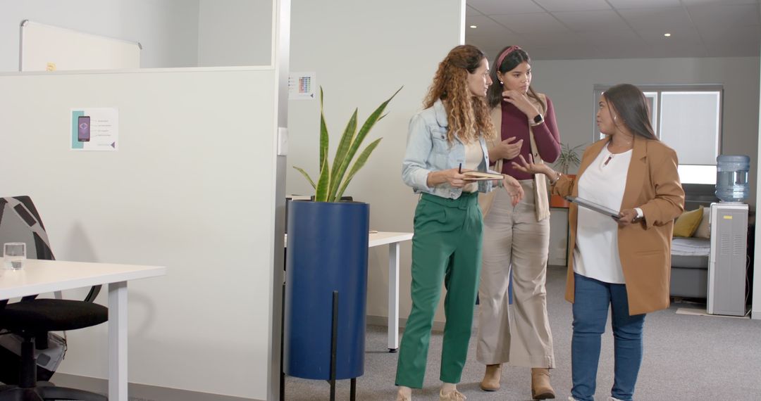 Team of Colleagues Discussing Projects Walking Office Corridor